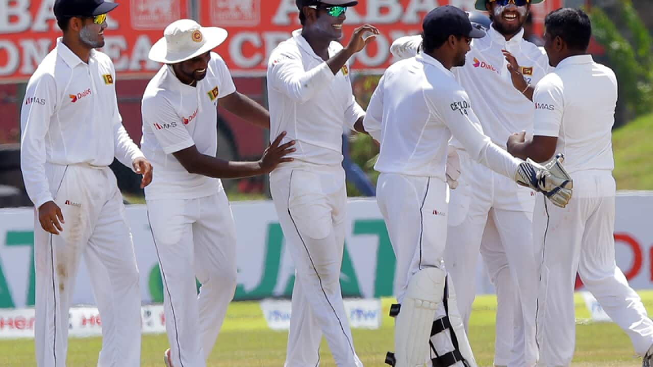 Sri Lankan cricketers celebrate after winning the first Test
