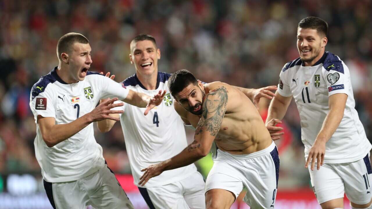 epa09582544 Serbia's player Aleksandar Mitrovic (2R) celebrates after scoring the winning goal against Portugal during the FIFA World Cup 2022 qualifying group A soccer match at Luz Stadium in Lisbon, Portugal, 14 November 2021. EPA/ANTONIO COTRIM