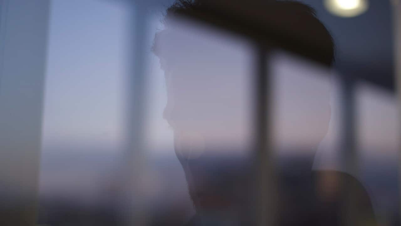 A man looking out a window.