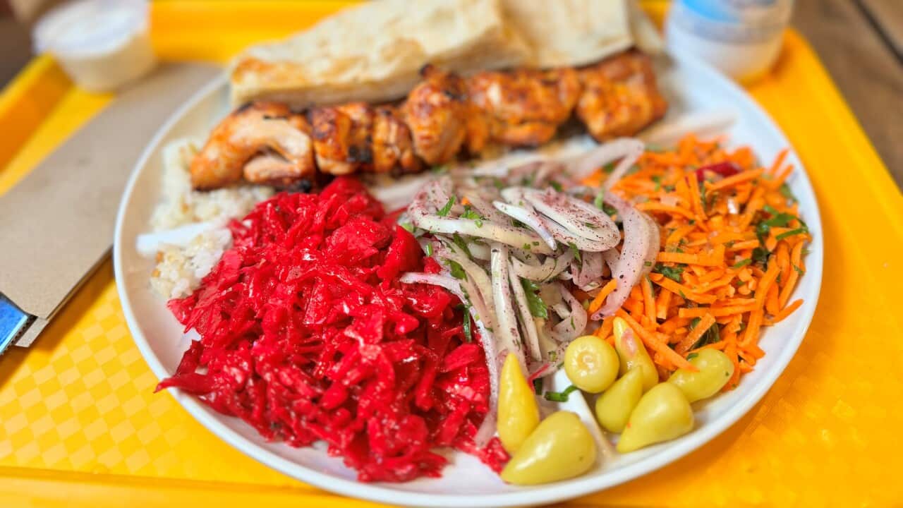 Kebab and vegetables on a plate.