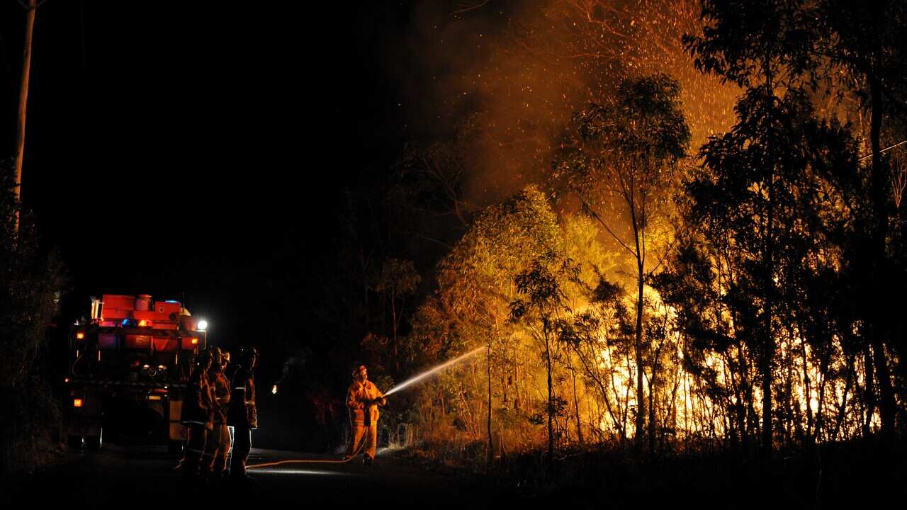 NSW RFS firefighters battle a bushfire burning close to homes on Patterson street at Springwood in the Blue Mountains west of Sydne