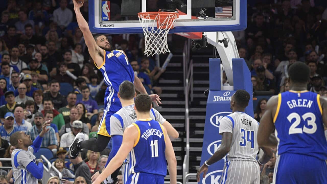 Golden State Warriors center JaVale McGee (C) goes up for a dunk