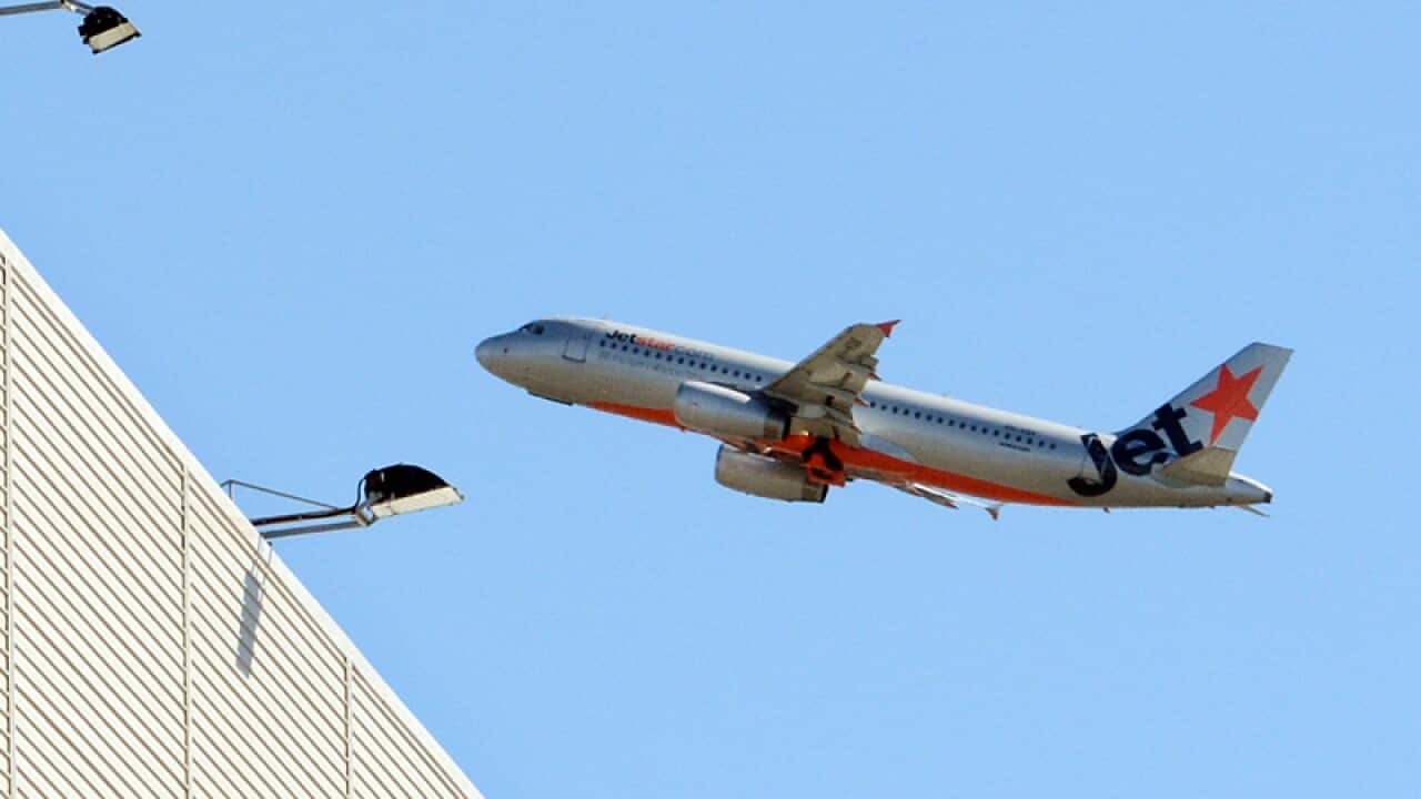 A Jetstar plane at the Qantas maintenance base at Brisbane Airport
