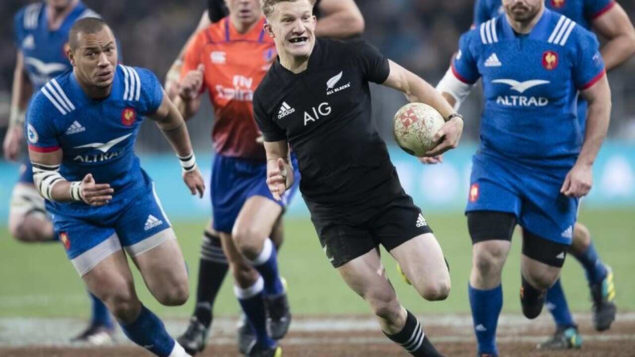 New Zealand's Damian McKenzie makes a break.