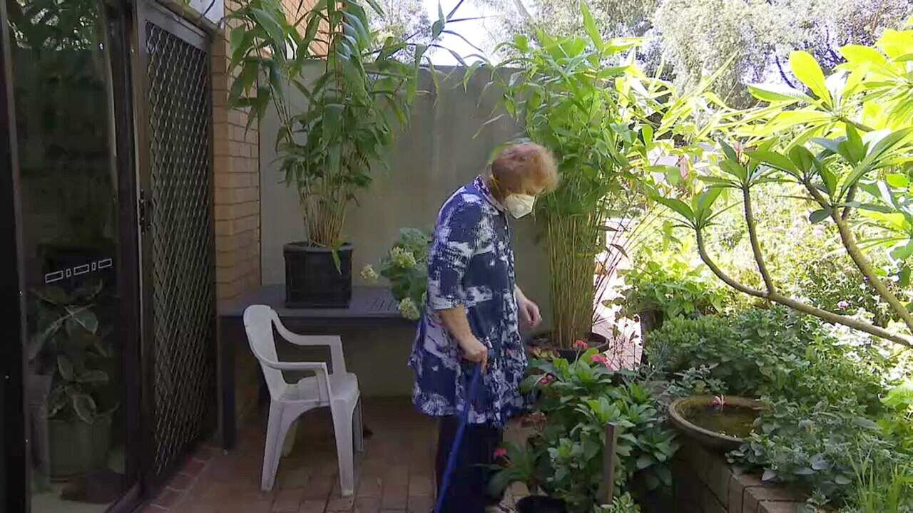 Marion Rae has to put on a mask to go outside in her garden