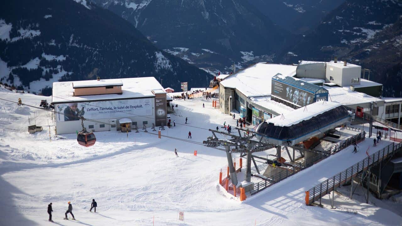 Skiers rides the slopes above the Swiss ski resort of Verbier in the Swiss Alps.