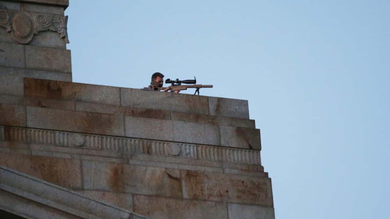A sniper poised in position on the roof of Melbourne's Shrine of Remembrance.