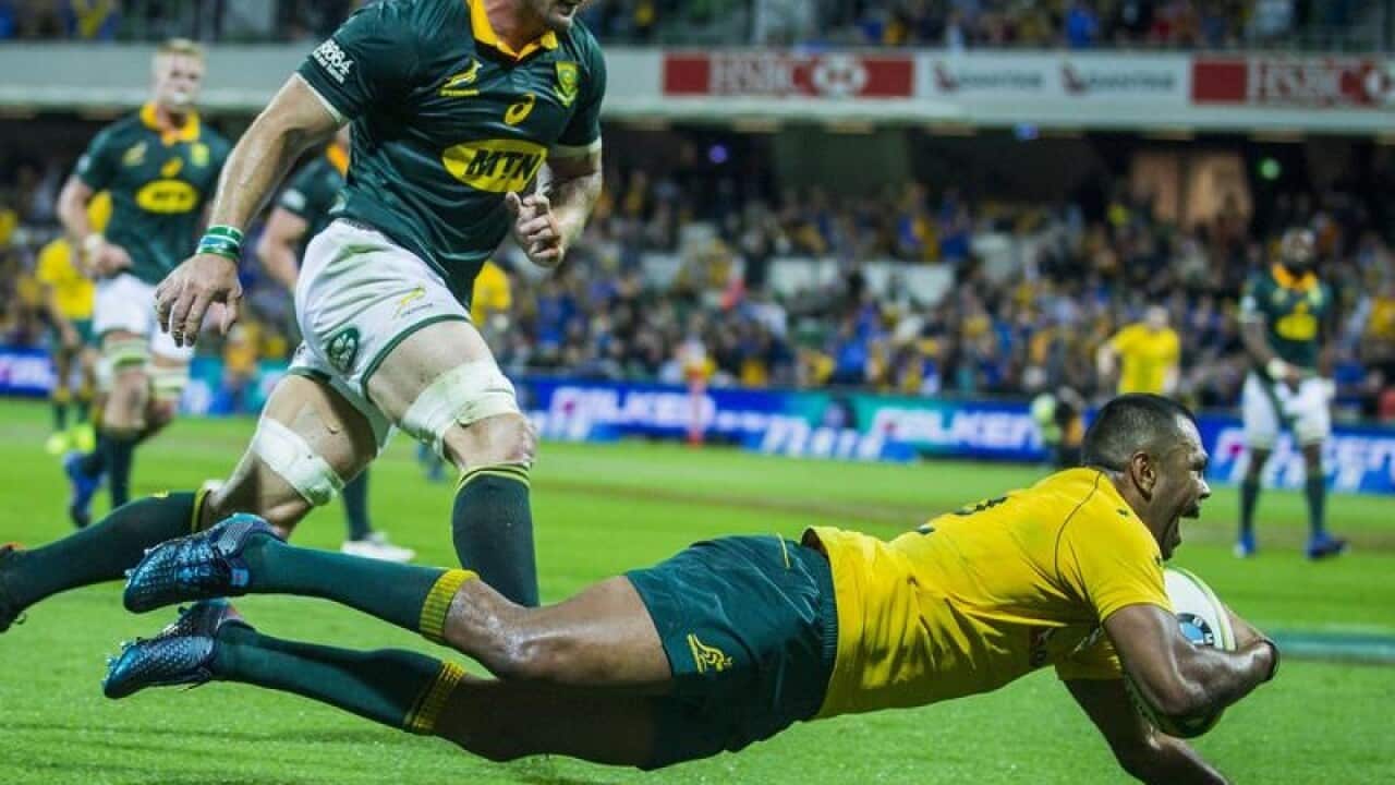 Kurtley Beale of the Wallabies scores a try.
