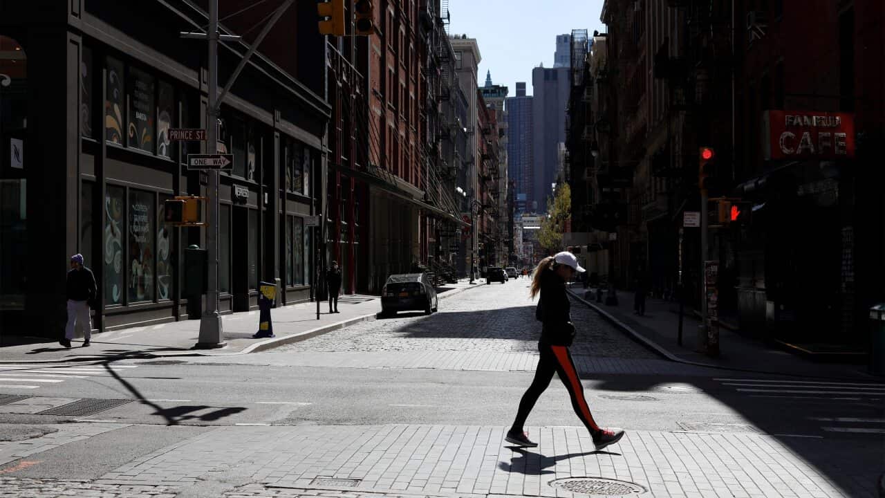 People walk in the quiet SOHO neighborhood in New York, New York, USA, 11 April 2020.