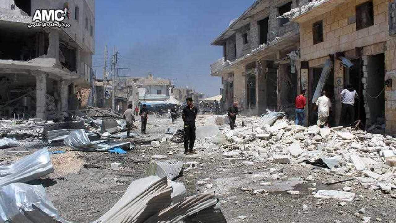 Syrian citizens inspecting damaged shops after airstrikes hit a market in Atareb, west of the divided city of Aleppo, Syria, Tuesday, Aug 2, 2016