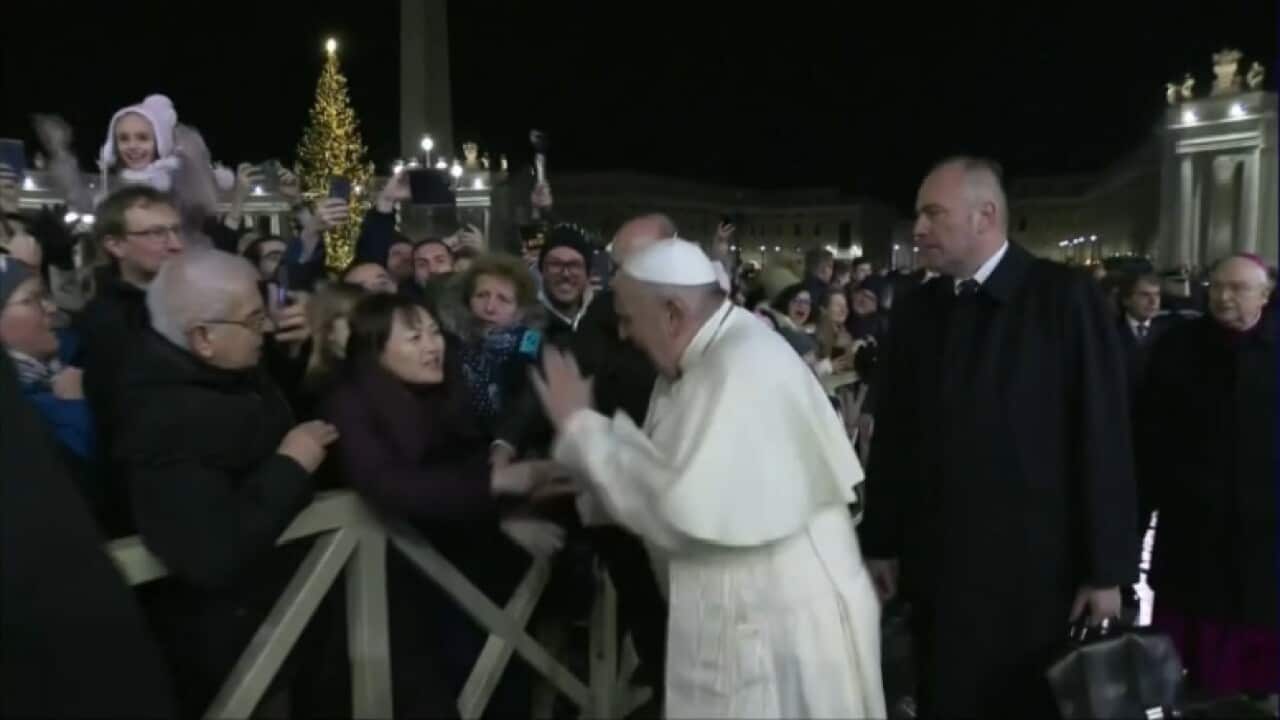 The woman's abrupt gesture appeared to cause he Pope pain and he swiftly wrenched his hand free.
