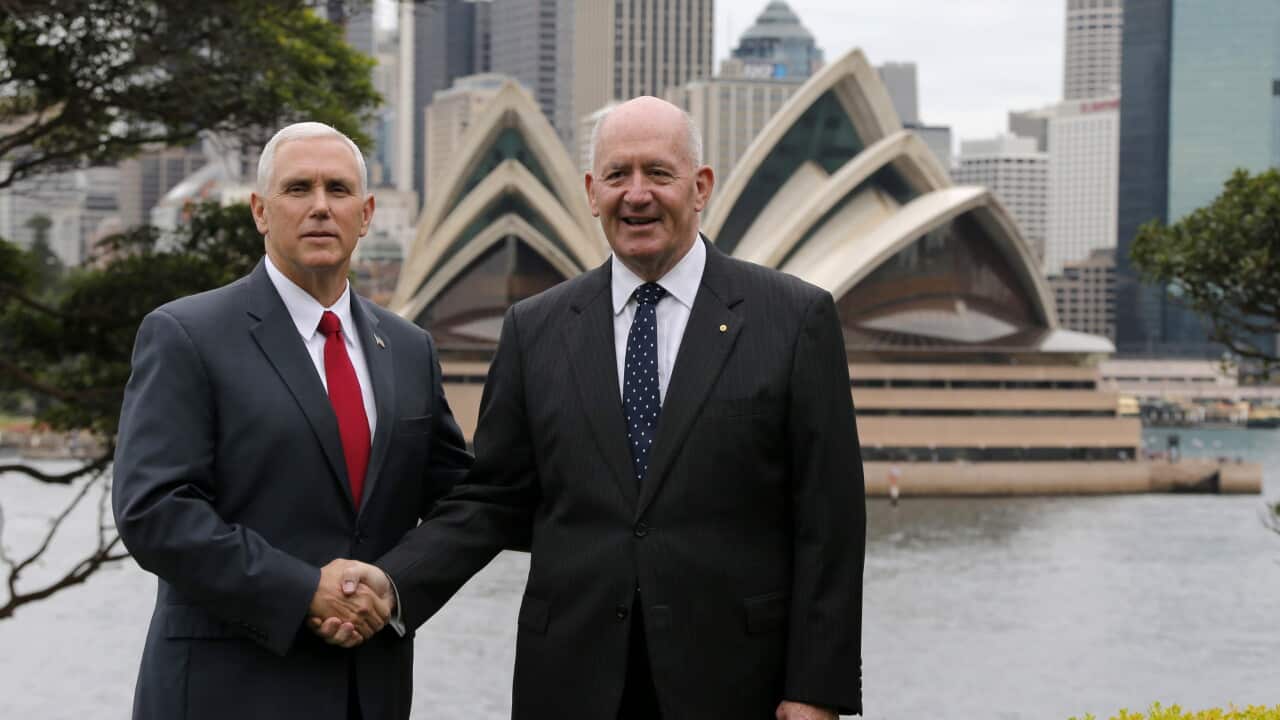 U.S. Vice President Mike Pence, left, with the Sydney Opera House at the back, shakes hands with Australia's Governor-General Peter Cosgrove