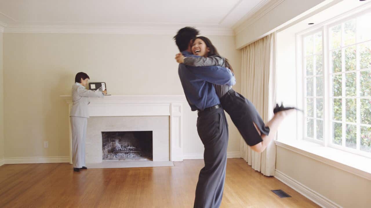 Couple embracing in new house