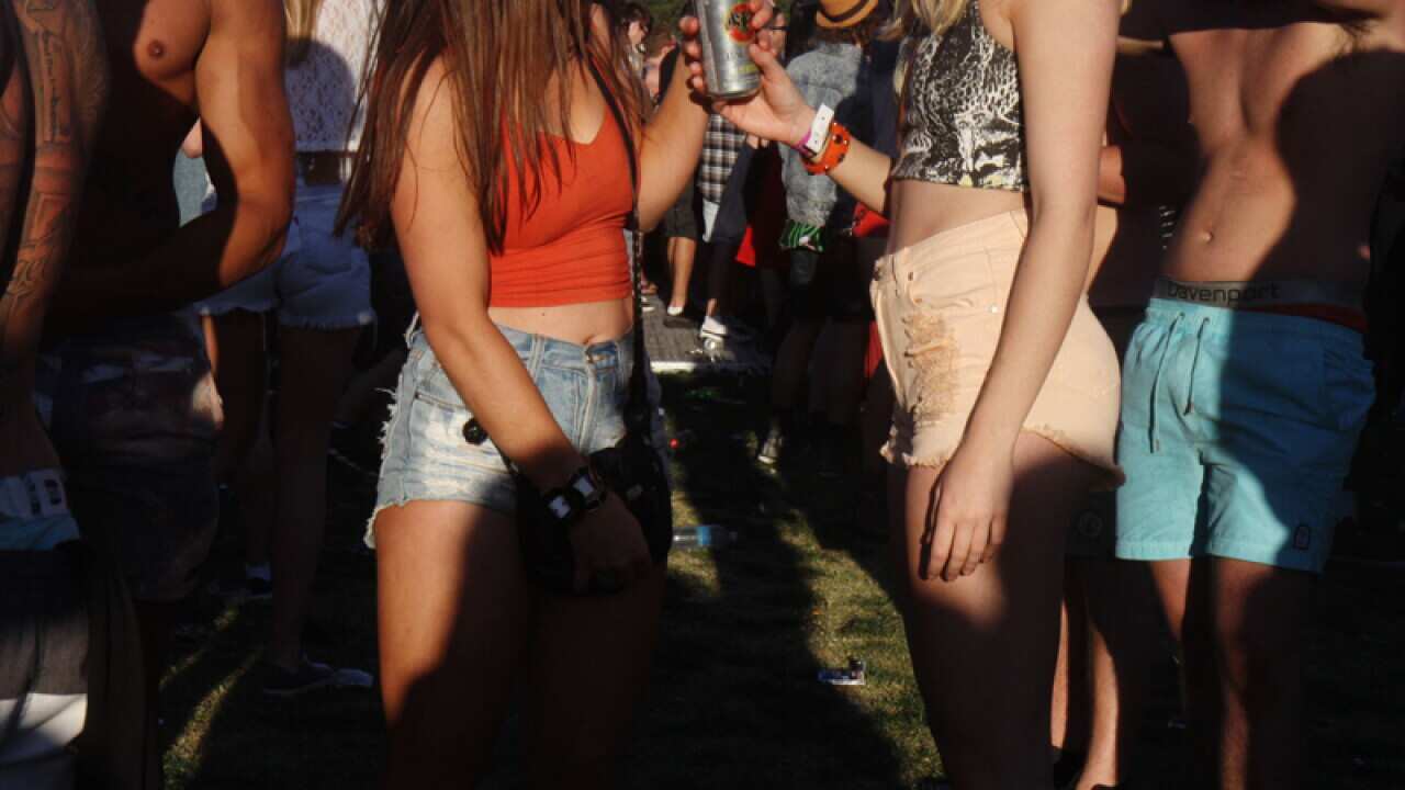 Young people drinking alcohol at a music festival