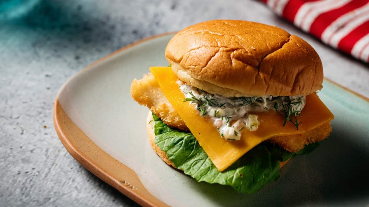 Crumbed fish burger with mustard leaves