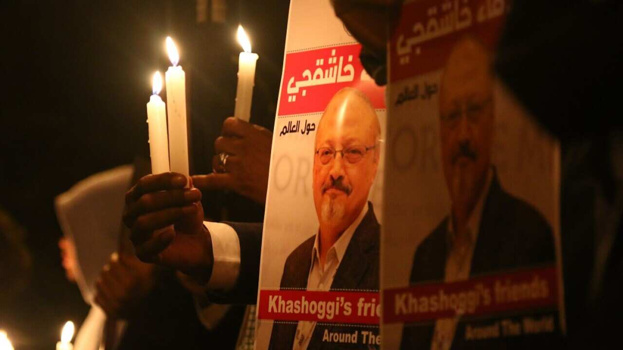 Activists, protesting the killing of Saudi journalist Jamal Khashoggi, hold a candlelight vigil outside Saudi Arabia's consulate in Istanbul.