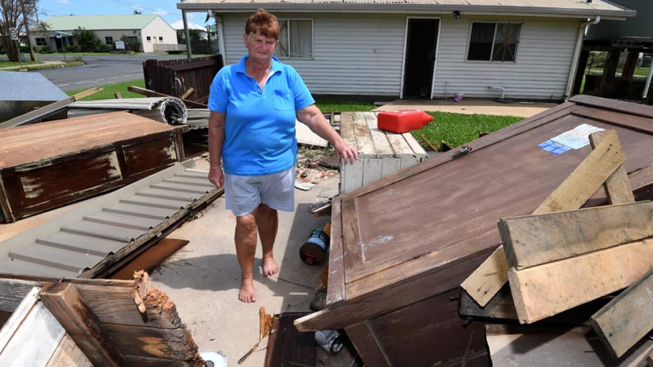 Helen Muller stands in the ruins of her double garage in Proserpine