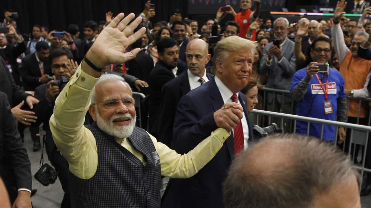 Indian Prime Minister Narendra Modi (L) and US President Donald J. Trump greet the crowd of over fifty thousand at the 'Howdy Modi' community summit