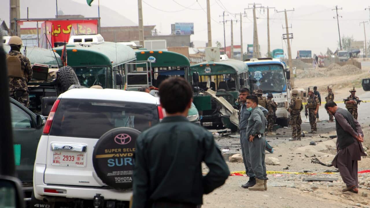 Afghan security officials secure the scene of a suicide bomb attack that targeted a police convoy on the outskirts of Kabul, Afghanistan, 30 June 2016.