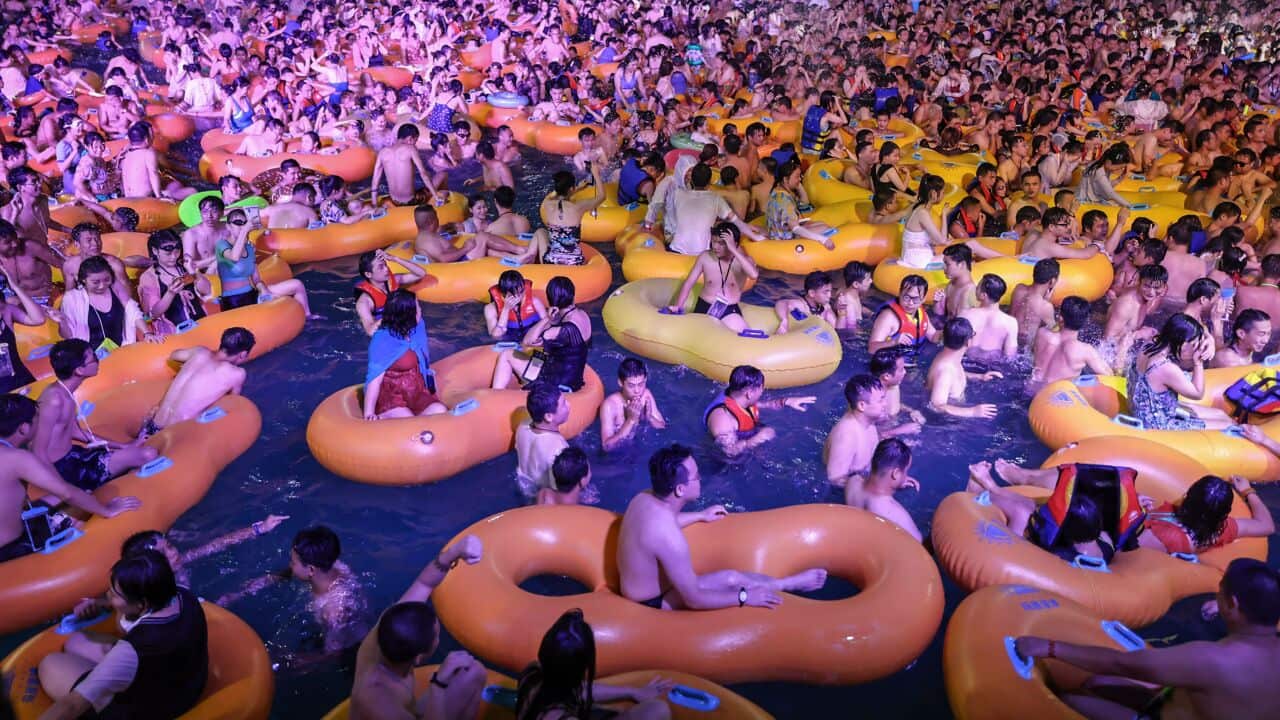 TOPSHOT - This photo taken on August 15, 2020 shows people watching a performance as they cool off in a swimming pool in Wuhan in China's central Hubei province. (Photo by STR / AFP) / China OUT (Photo by STR/AFP via Getty Images)