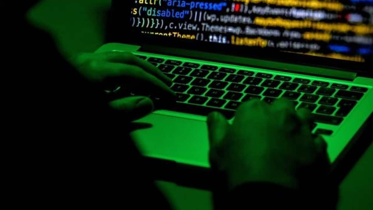 A person sits in front of a computer screen