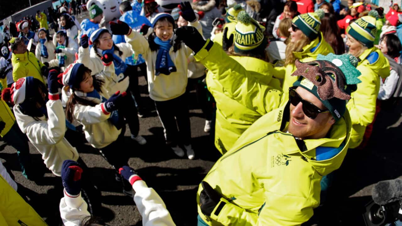 Australian cross country skier Phil Bellingham dances during a welcoming ceremony