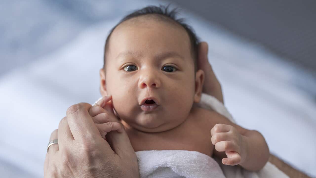 Close up photo of a one week old baby boy