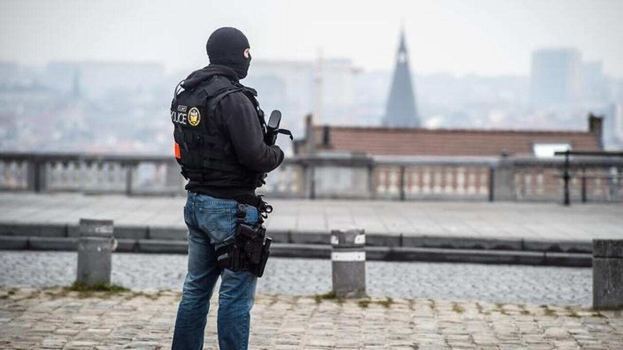A police officer stands guard outside the court w in Brussels, Belgium.