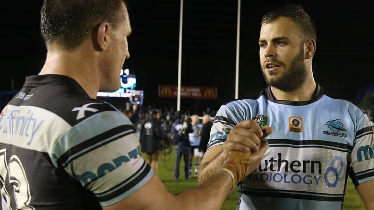 Wade Graham of the Sharks (R) is congratulated by teammate Paul Gallen