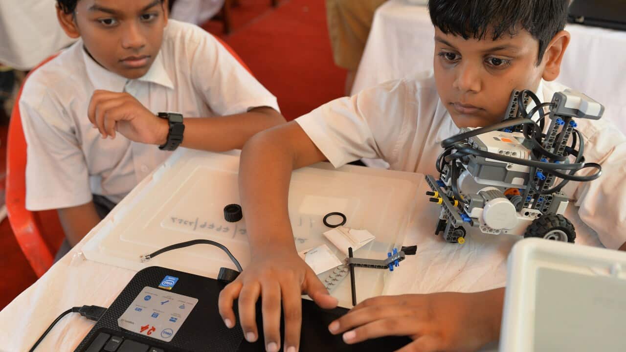 Students operation a laptop