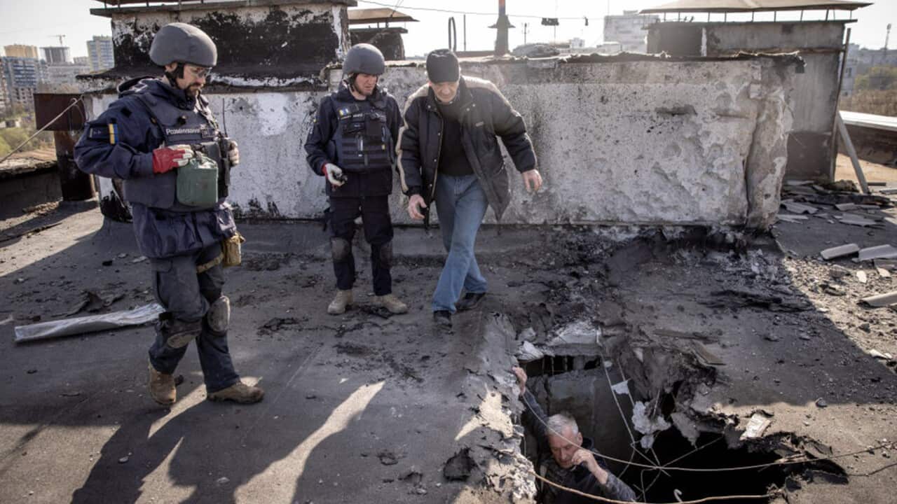 A resident assesses roof damage in Kharkiv (Getty).jpg