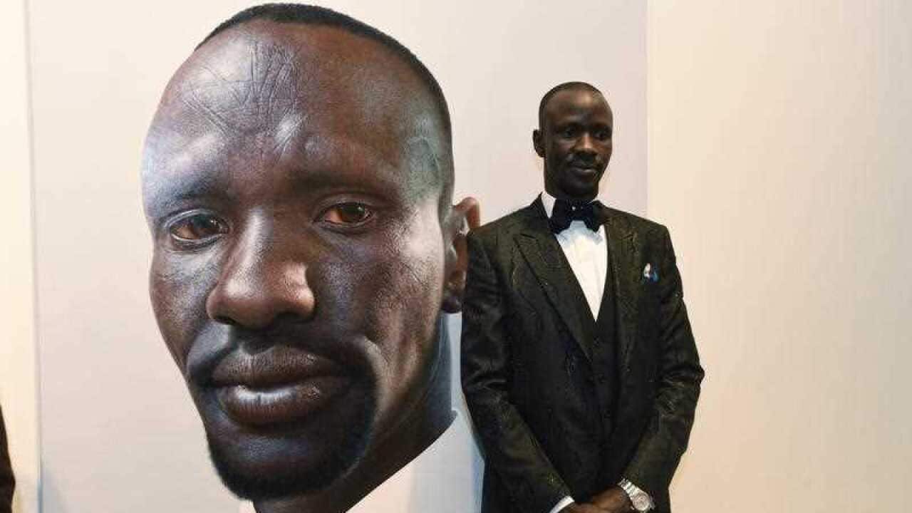 Lawyer Deng Adut with the Archibald Prize People's Choice Award at the Art Gallery of NSW in Sydney, Wednesday, Sept. 21, 2016.