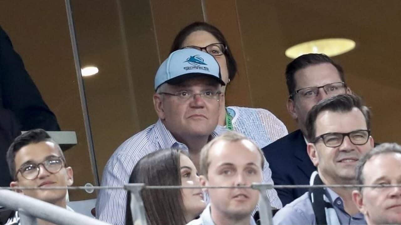 Prime Minister Scott Morrison watches on during NRL match