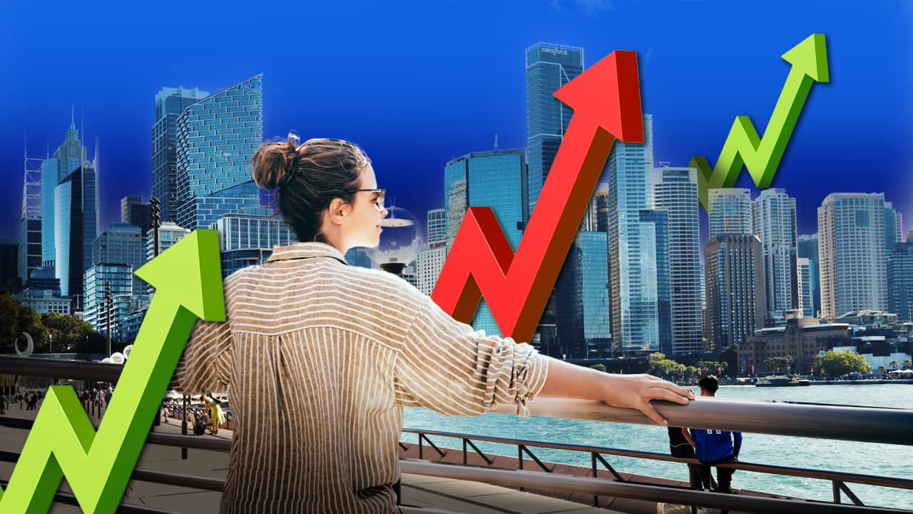 A woman looks across the water at high rise buildings, she is surrounded by large arrows pointing up