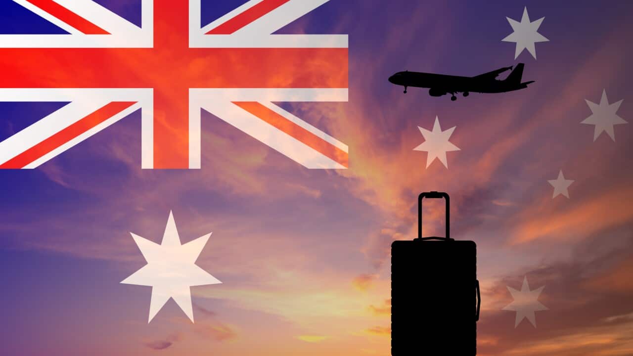 Suitcase and airplane against the background of the Australian flag