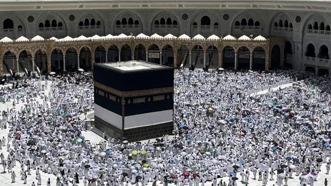 Prospective pilgrims perform the last Friday prayer before Eid al-Adha in Mecca