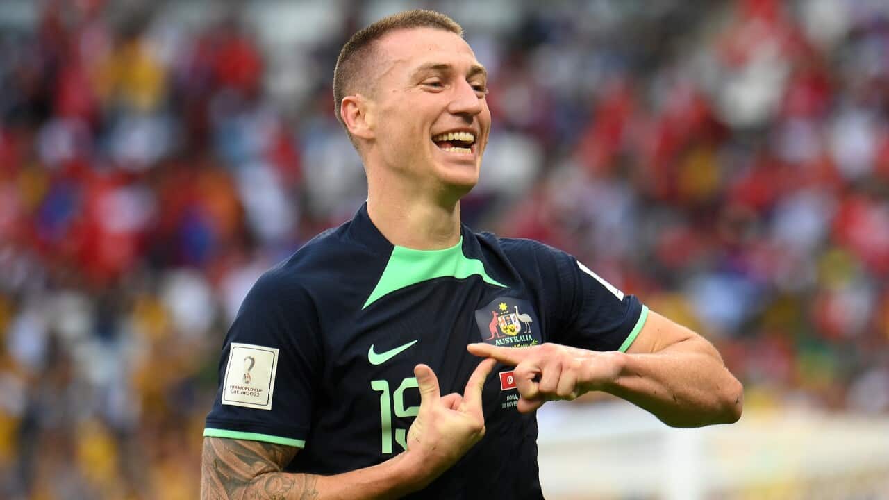 Mitchell Duke from the Socceroos makes a signal with his hands