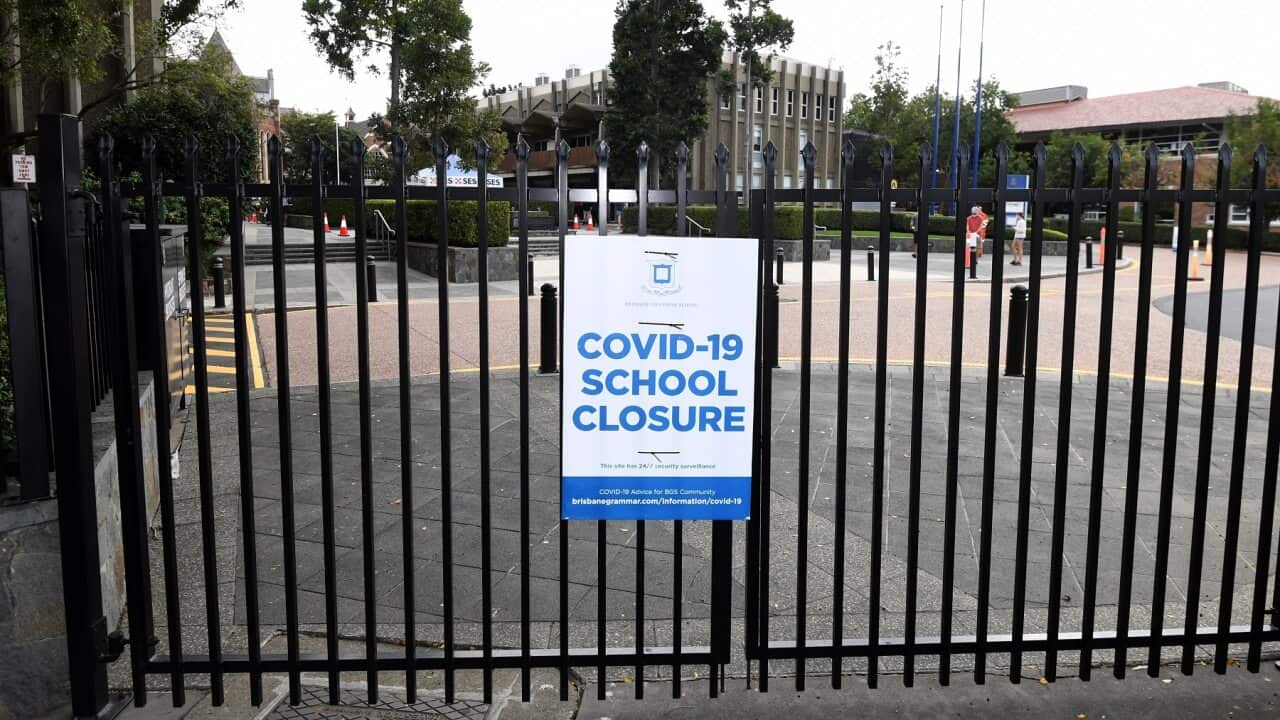 A Covid-19 closure sign on the gate of a school