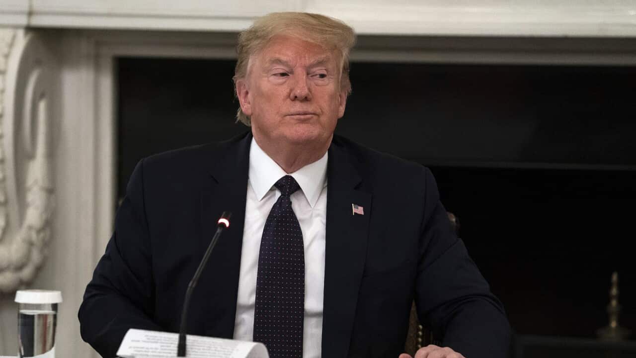 President Donald Trump gets up at the conclusion of a meeting with restaurant industry executives about the coronavirus response, in the State Dining Room of the White House, Monday, May 18, 2020, in Washington. (AP Photo/Evan Vucci)