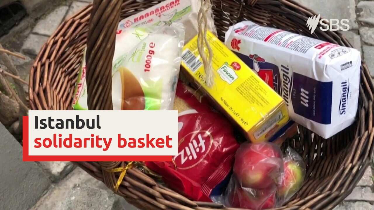 This man is helping his neighbours in need by hanging out a 'solidarity basket'