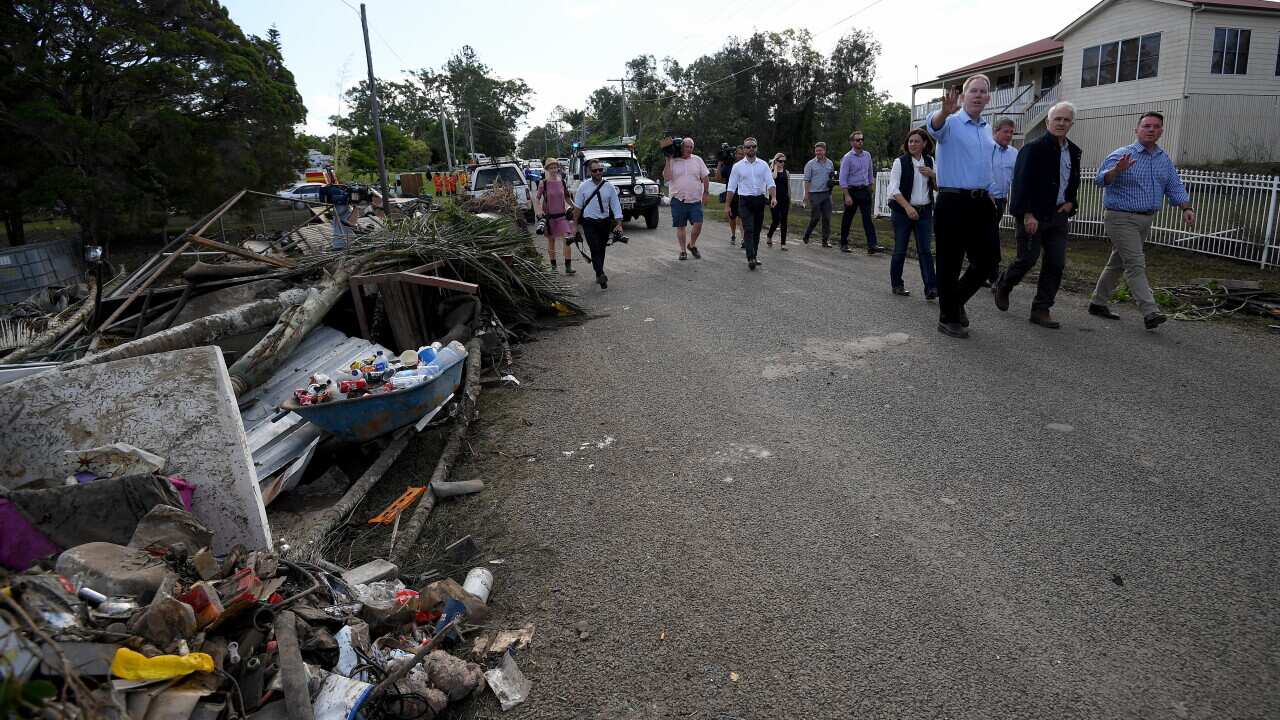 Malcolm Turnbull inspects a flood affected street in Eagleby, Queensland.