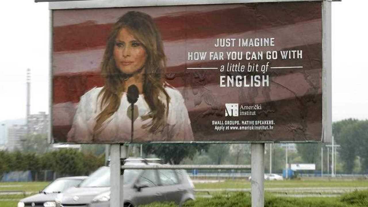 Cars drive behind a huge advert poster of the 'American Institute' promoting its English language courses with a photo of US First Lady Melania Trump, in downtown Zagreb, Croatia, 16 September 2017.