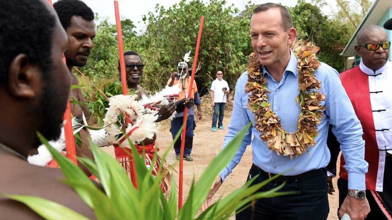 Tony Abbott visiting the grave of land rights activist Eddie Mabo on Mer Island in the Torres Strait.