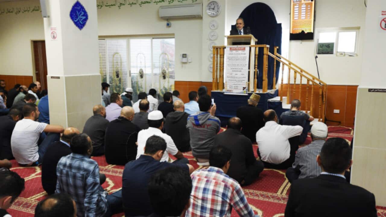 Parramatta Mosque chairman Neil El-Kadomi speaks to worshippers at Parramatta Mosque during a Friday prayer