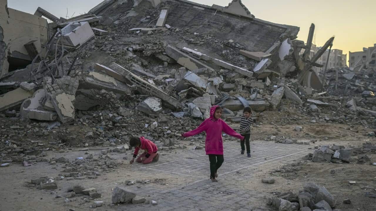 Children playing in the ruins of collapsed buildings.
