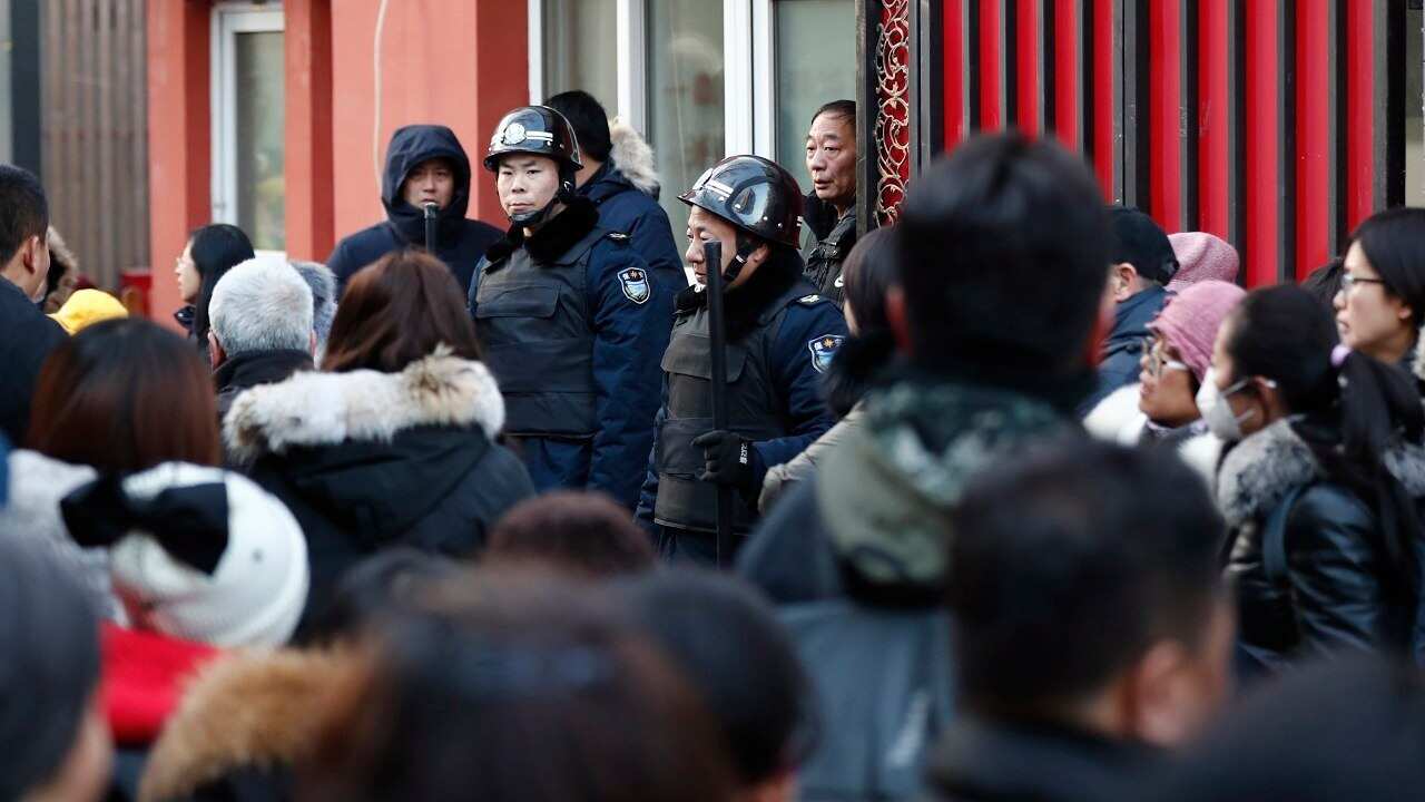 Two security guards in front of the school.