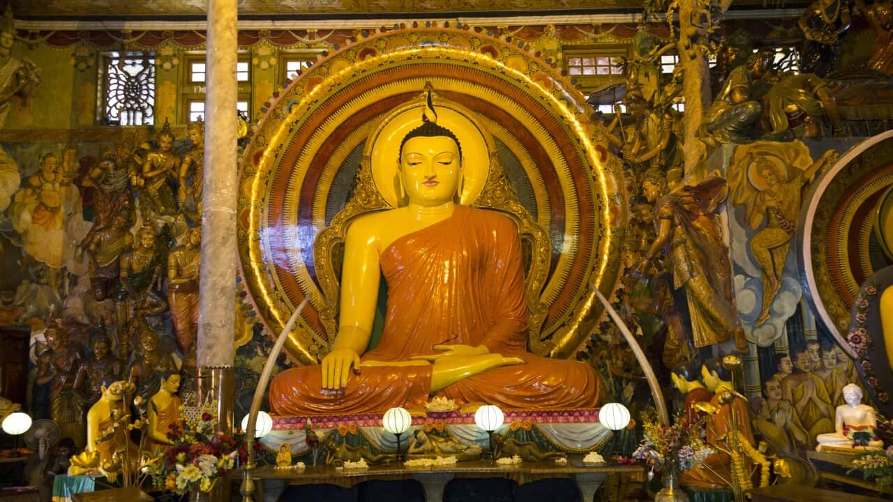 Large Buddha statue at Gangaramaya Temple, Colombo, Sri Lanka,