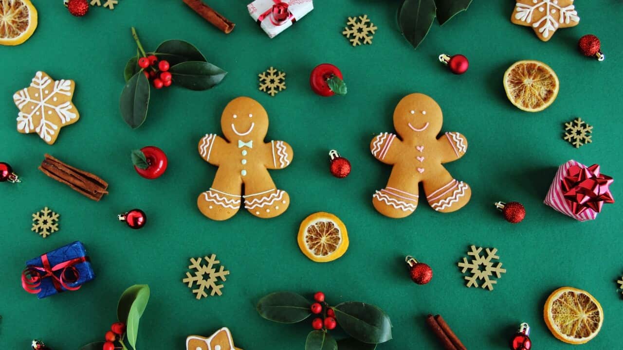 Christmas pattern made with various winter and Christmas objects on green background.