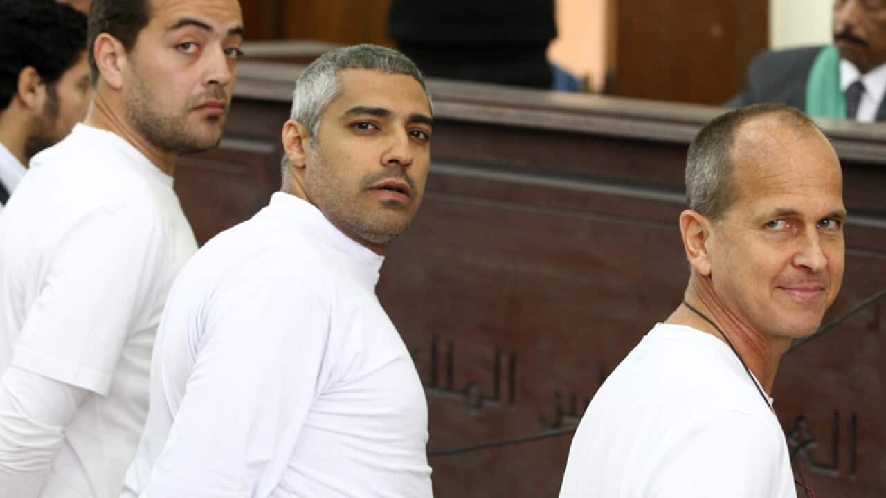 Canadian-Egyptian journalist Mohammed Fahmy (c), Peter Greste (r).