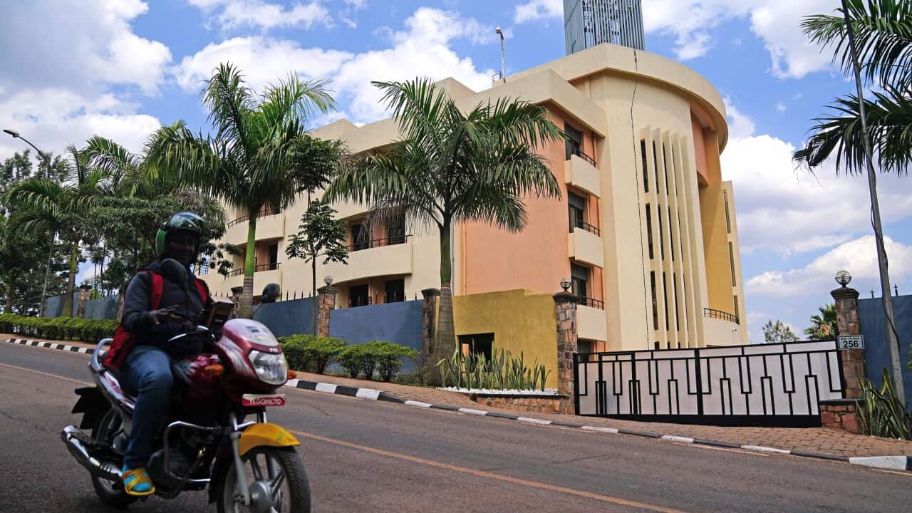 A person on a motorbike rides past the Hope Hostel accommodation in Kigali, Rwanda.